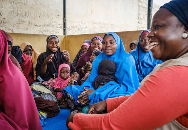 Women participate in a sensitization activity at Sulumburi Health Clinic.