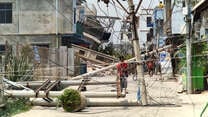 A man examines a downed power line caused by the earthquake in Myanmar.