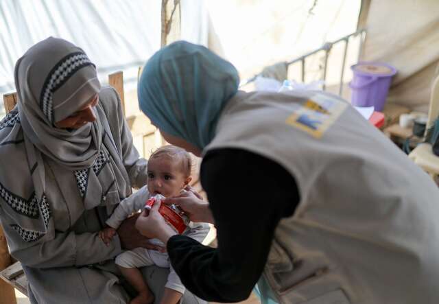 An IRC malnutrition officer treats a Palestinian baby for malnutrition in Gaza.